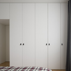 Room with many white wardrobes