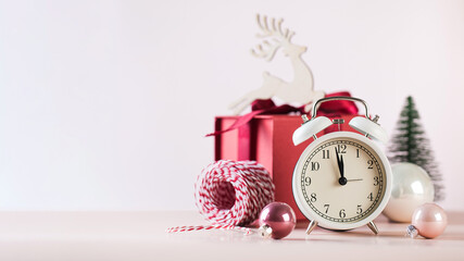 Christmas composition with alarm clock baubles and gift box. Copy space.