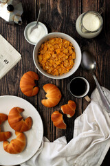 Italian breakfast with coffee, milk and croissant