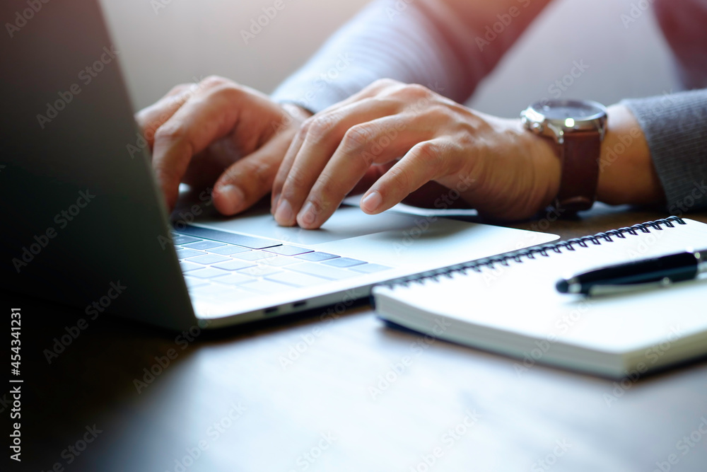 Poster man hand using and typing keyboard of laptop computer on office desk. workspace, businessman working