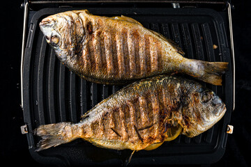 cooking process dorado fish on the grill fried fish is ready for serving