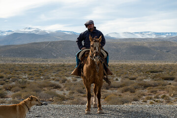 Neuquen, Argentina, July 21, 2021; Argentine cowboy (gaucho) walks his horse past camera, in...