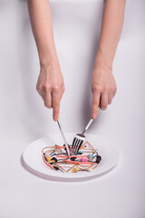 Female hands, fork, knife and plate. White background.