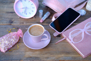 womens stylish accessories, smartphone with blank screen, glamorous set in pink shades, flat lay, copy background, womens clothing, alarm clock, lipstick, coffee cup, good morning concept, female life