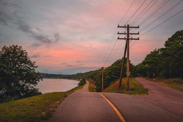 Road travel landscape over the Cape Cod Canal Bikeways at sunrise in the summer. Pink seascape at dawn in Bourne in Massachusetts.