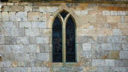 Fototapeta na wymiar Medieval window in stone wall