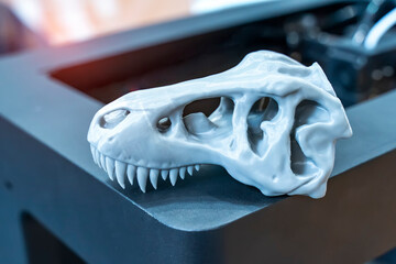 3D printer printing dragon head figure close-up.