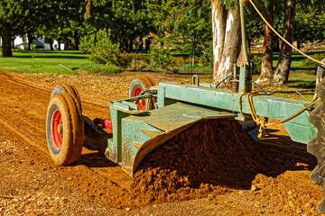 Tractor drawn road grader on gravel road