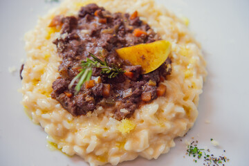 Top view of risotto on white plate. Gourmet Mediterranean food concept