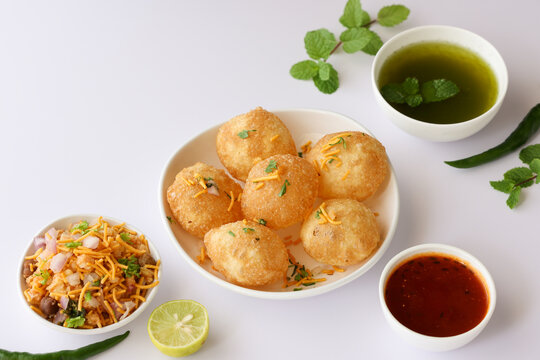 Girl women taking spicy Pani puri golgappe with hand, Chat item, India. Indian panipuri snack eaten with tangy tamarind water, potato stuffing, North Indian street food Delhi, Mumbai, Rajasthan