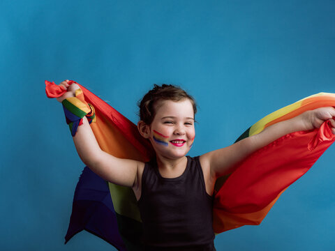Cheerful girl holding multicolored flag