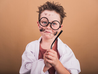 Crazy scientist boy with dirty face and glasses temple