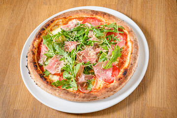 pizza with ham and rocket salad