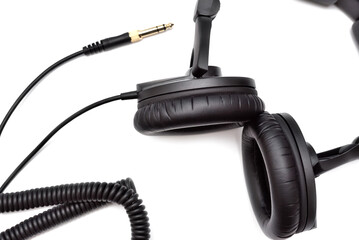 Top view of black wired stereo headphones. Professional studio headphones for listening, mixing and recording music.