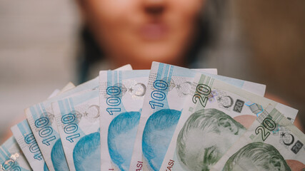 The girl's Hands holding Turkish Lira and American Dollar. Concept of the money exchange