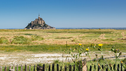 Summer view  of the famous historic Mont-Saint-Michel on the background of the blue sky.Saint...
