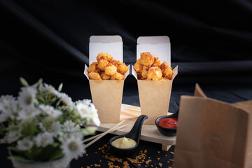 Chicken pop, hot, smoky, with a black background as a snack.