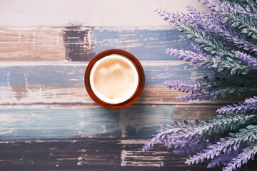 herbal cream cosmetic in a container on table,