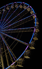 ferris wheel at night with lights in the city of Cagliari - Sardinia - travel destination.