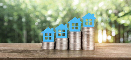 Model house mock up on coins. property real estate investment 