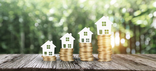 Model house mock up on coins. property real estate investment 