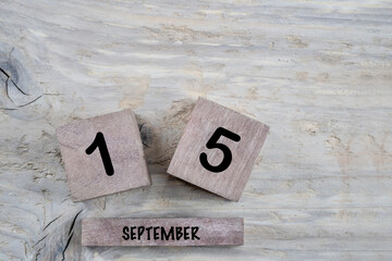 cube calendar for september on wooden background with copy space