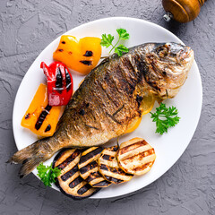 grilled dorado served on a plate with vegetables