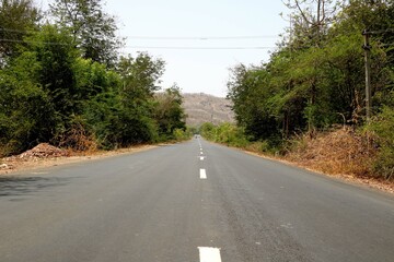 Rural Roads in India leading to the village at the distance
