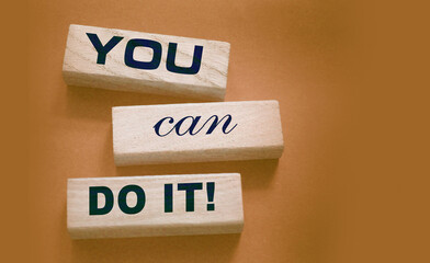 YOU CAN DO IT word on wooden blocks on gray background. Motivation affirmation encouraging words...