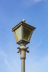 Fototapeta na wymiar Vintage iron lantern in a public park in the daytime