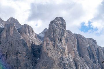 Alta Badia (Dolomiti) - August: Beautiful summer mountain view of Passo Sella and high peak Sassopiatto and Sassolungo, Langkofel, Dolomiti, Sella group. Green meadows and pastures, alpine dolomites