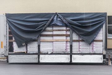 Belarus, Gomel region - August 21, 2020: Unloading a trailer of a truck or vehicle with a cargo of building materials