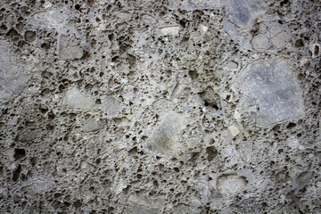 evocative image of very porous concrete wall
