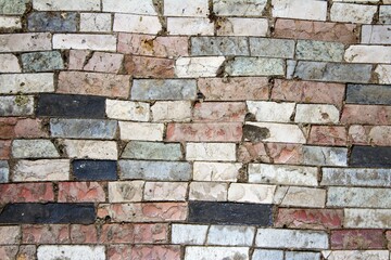 evocative image of tile wall of various uneven colors