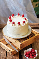 Chocolate raspberry cake with raspberry cheesecake layer. Decorated with berries. Side view