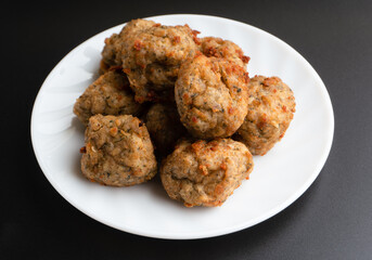 Chicken kofta meatballs mixed with ingredients of onions, garlic fresh herbs and spices mixture on black background