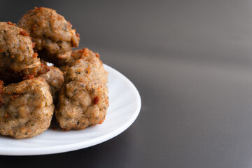 Chicken kofta meatballs mixed with ingredients of onions, garlic fresh herbs and spices mixture on black background