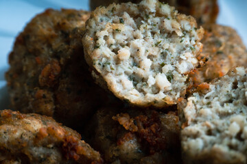 Chicken kofta meatballs mixed with ingredients of onions, garlic fresh herbs and spices mixture on black background