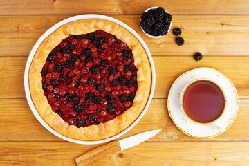 Homemade open pie gallet with raspberries, blackberry and grapes. Top view.