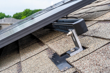 Rail, bracket, and anchor to a solar panel installed on a asphalt shingle roof