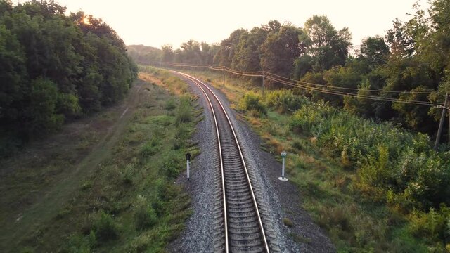 Sunrise on the railway tracks in the forest