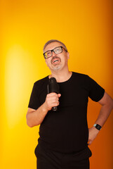 A male singer in his 50s yells text, a place for text, a concept for a presenter into a microphone.