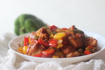 Chilli Chicken is a sweet, spicy and crispy appetizer. Made with Marinated and air fried chicken chunks in a dry gravy of onions bell peppers and sauces.