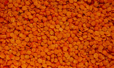 Red lentils, edible legume background.