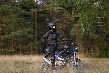 Obraz premium girl on a motorcycle in the open air. the way of life of a real person.