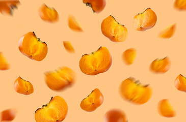 Colorful Flying, Floating persimmon. Beautiful orange persimmon fruit card.Harvest time, autumn, farming. Healthy eating and food concept.Creative layout, background with persimmon.Template for design