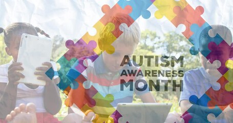 Animation of colourful puzzle pieces and autism text over school children using tablets - Powered by Adobe