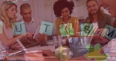 Animation of colourful puzzle pieces, autism text over business colleagues with electronic devices - Powered by Adobe