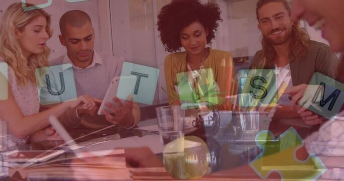 Animation of colourful puzzle pieces, autism text over business colleagues with electronic devices - Powered by Adobe