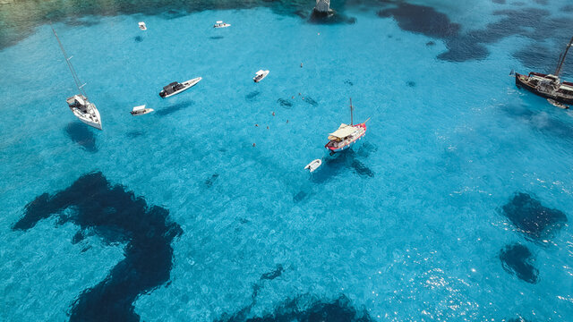 drone shot blue water in milos and poliegos